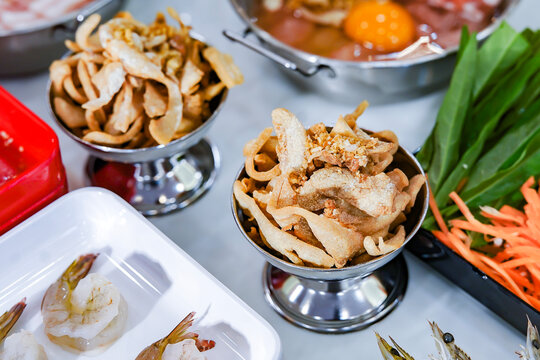 Thai Pork BBQ Buffet (Mu Kratha) &ndash; Delicious grilled sliced pork and fresh vegetables on a traditional dome skillet. Perfect for street food, Asian cuisine, and dining background graphics.