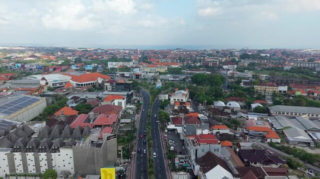 Aerial view of the Statue of Dewa Ruci roundabout surrounded by urban buildings and roads in Kecamatan Kuta, Bali, Indonesia.