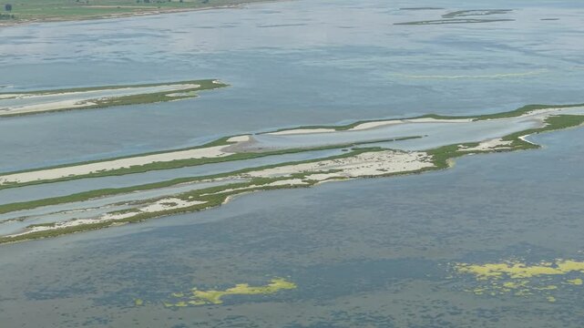 Aerial view of Karavasta Lagoon with its sandy islands and calm waters in Divjake, Fier County, Albania.
