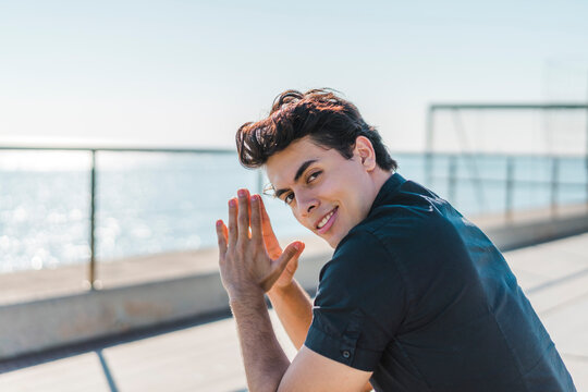 Portrait of smiling young man at the coast