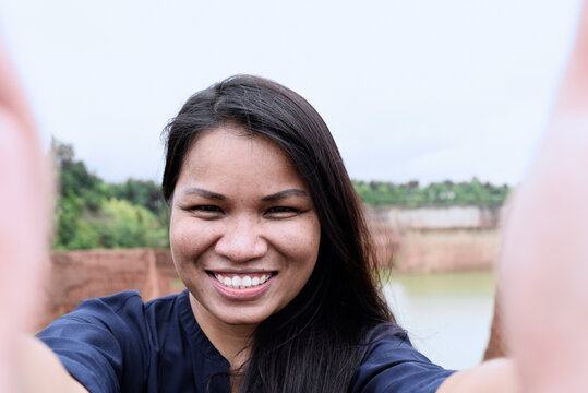 Thailand, Chiang Mai, self portrait of smiling young woman