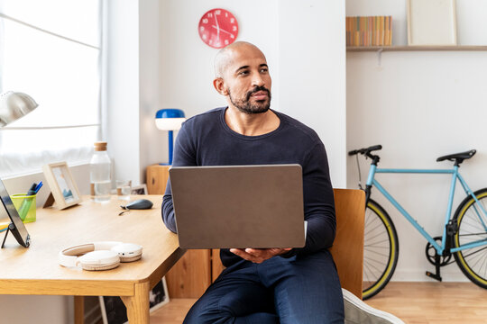 Remote professional working with laptop in modern home office