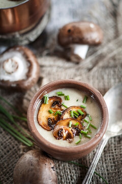 Bowl of mushroom cream soup with chive and fried mushroom