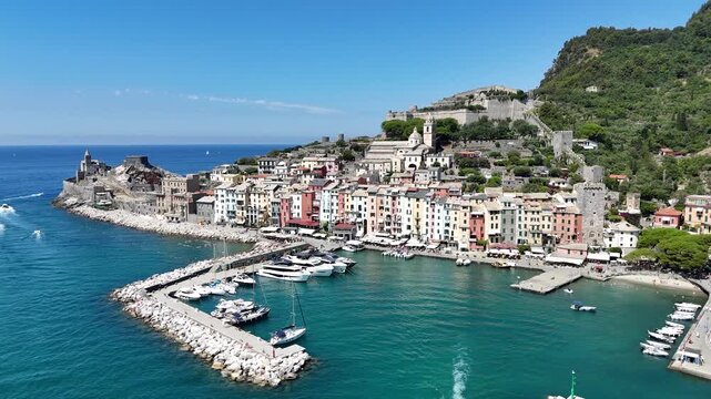 Aerial approach to Portovenere waterfront, marina and Doria Castle in Italy