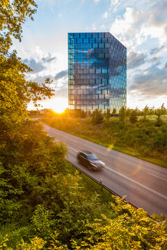 Germany, Stuttgart, view to modern office building with reflection of clouds on glass facade