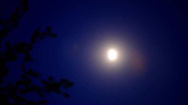 Moon on a twilight sky with landscape mountain silhouettes.