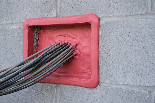 Intumescent Firestop Mastic Sealing Cable Penetration In Blockwork