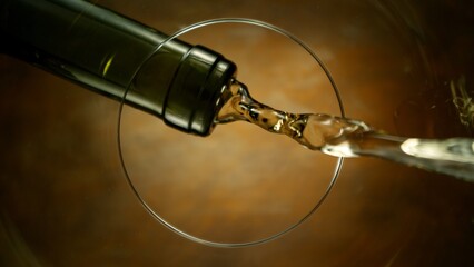 Naklejka premium White Wine Pouring Into Glass From Below