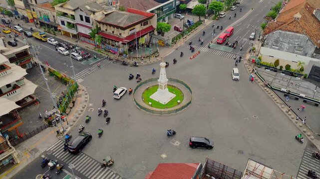 Aerial view of Tugu Yogyakarta Monument surrounded by traffic and city streets in Yogyakarta, Special Region of Yogyakarta, Indonesia.