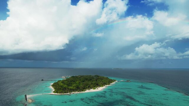 Aerial view of Meedhupparu island surrounded by turquoise lagoon waters and coral reefs in Raa Atoll, Raa Atoll, Maldives.