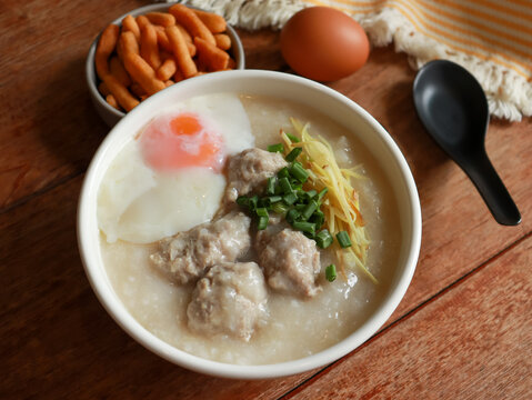 Congee or rice porridge top with minced pork, ginger and green onion. Popular breakfast bowl in China, Thailand, and Asia.