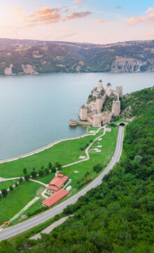 Golden-hour light warms the ancient towers of Golubac Fortress along the Danube at sunset