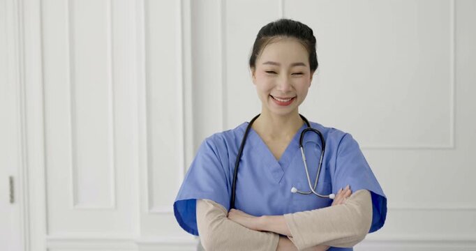 Female asian doctor using laptop for online consultation in a medical office, representing telemedicine, healthcare communication, and virtual patient clinic care.
