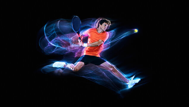 Male badminton player lunges toward shuttlecock through blue and pink energy streams. Concept of badminton gear, club training and tournament promotion.