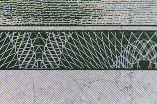 Extreme macro close up of microprinting typography and security pattern on US dollar banknote
