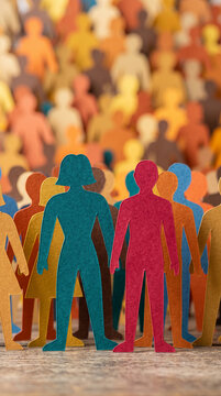 Paper cutouts of diverse human figures in vibrant colors, representing community and unity, perfect for conceptual themes.