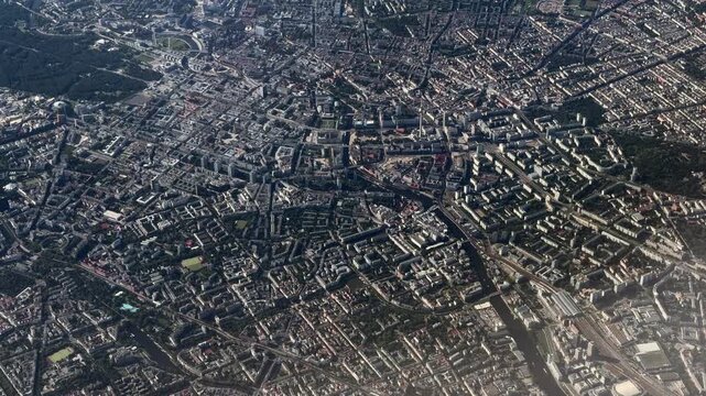 4k aerial video footage, flying across City of Berlin, Capital of Germany - from Alexanderplatz with Fernsehturm, Tiergarten park to western part of Berlin with Olympiastation and closed Airport Tegel