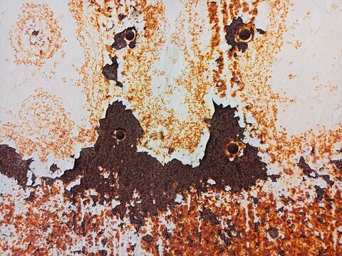 Weathered white painted metal with rust and peeling paint texture