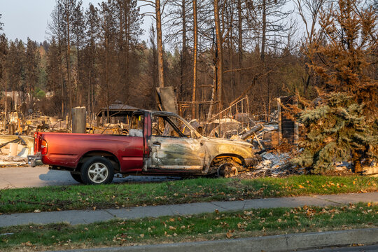 Spokane, Washington, United States - 14 August 2026: View of a burnt pickup truck and charred trees in the aftermath of the 2026 Spokane wildfires.