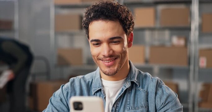 Happy, man and phone in small business for shipping, package dispatch or sales target in logistics. Staff, person or laugh with mobile for good review, delivery confirmation or typing digital receipt