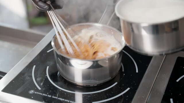 Chef cooking caramel sauce on induction cooker