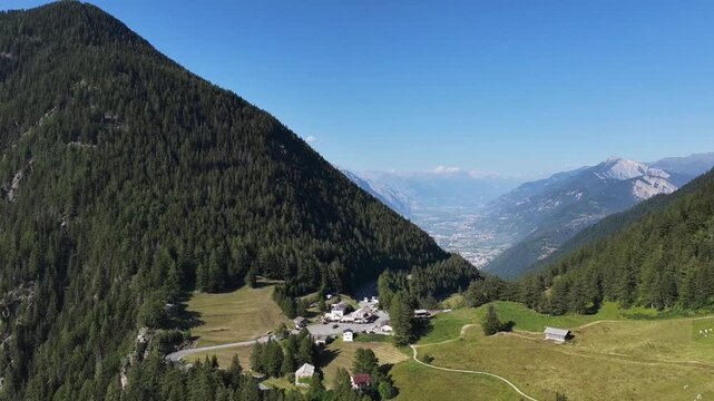 serene mountain landscape with greenery and blue sky in aerial view of valley with mountains in the background, nature scenery with natural materials and peaceful mood.