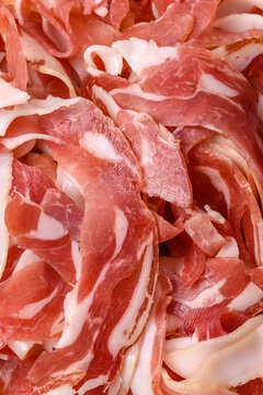Slices of pork pancetta, ham, or bacon for a festive antipasto platter