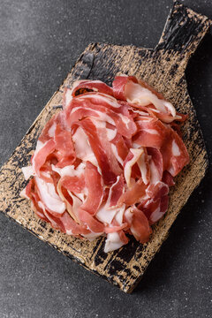 Slices of pork pancetta, ham, or bacon for a festive antipasto platter