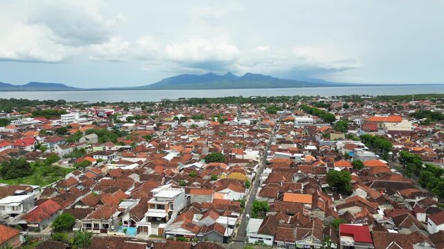 Banyuwangi East Java Indonesia Local Neighborhood Bali Island In Distance Drone Shot 4K 60FPS