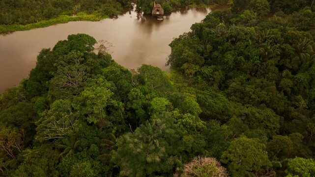 Breathtaking aerial footage flying over the amazon rainforest revealing a remote indigenous village