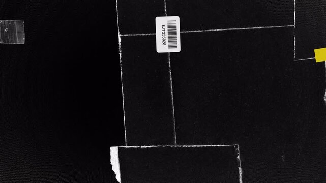 A close up view of a barcode label on a black surface.