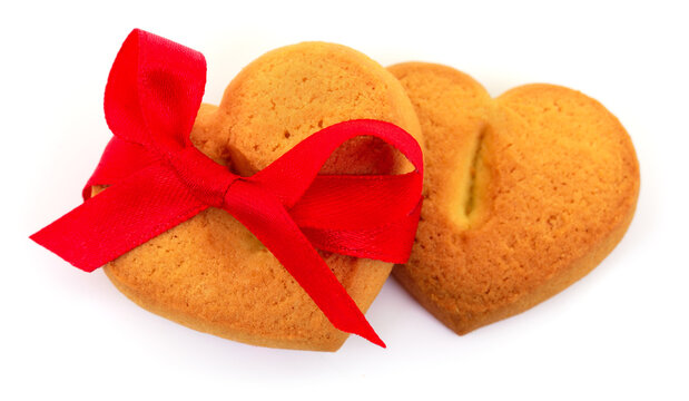 Heart shaped cookies tied with red ribbon isolated on white background
