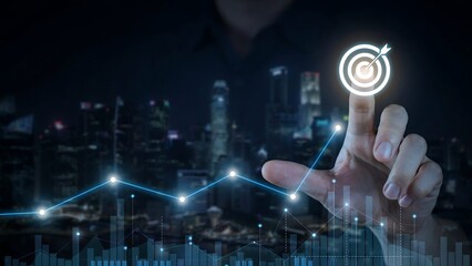 Fototapeta premium A hand pointing at a glowing target with an arrow, superimposed on a city skyline with a rising graph. This imagery represents achieving goals and business success.