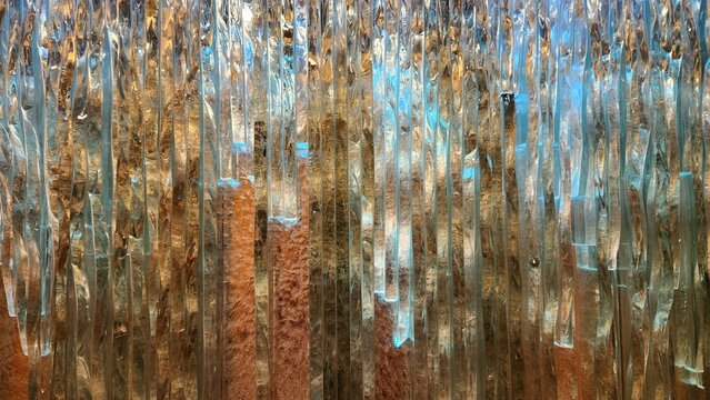 Abstract textured glass background with vertical ridges and contrasting warm amber and cool blue lighting