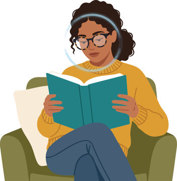 Woman sitting comfortably in an armchair while reading a book.