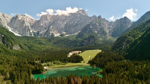 Aerial view of the Fusine Lakes and surrounding conifer forest below the Julian Alps near Tarvisio, Friuli-Venezia Giulia, Italy
