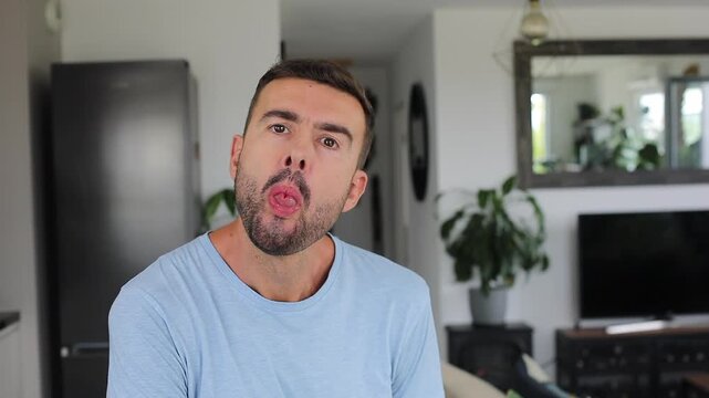Man making a coned shape with his tongue at camera