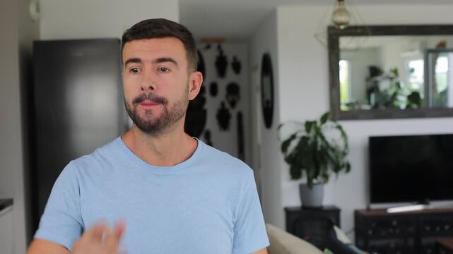 Man putting two fingers in his mouth to blow a loud whistle toward the camera before smiling