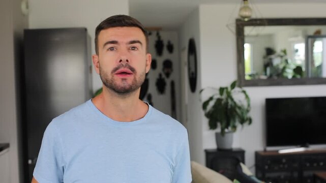 Man putting two fingers in his mouth to blow a loud whistle toward the camera before smiling