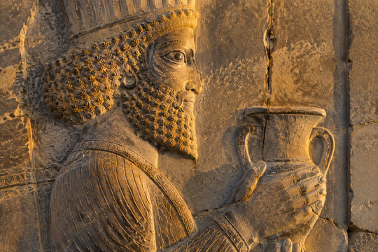 Weathered stone bas-relief from Persepolis depicting a tribute bearer.