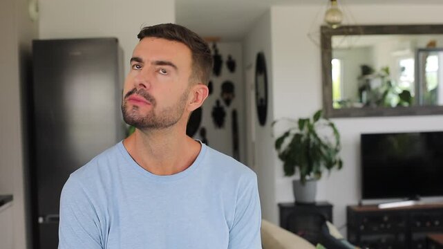 Man deep in thoughts with his hand on his chin before having a sudden realization and smiling.