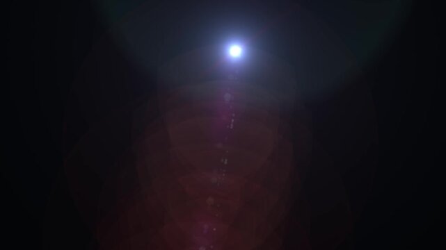 Blue lens flare effect with cinematic optical light flash, glowing lens rings and subtle red purple reflections on a dark abstract background