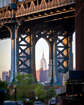 New York City, USA; 5th May 2010: The famous New York landmark the Empire State Building as seen through the Manhattan Bridge in Brooklyn