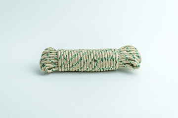 Rolled bundle of green and white twisted string rope isolated on white background © arbi wiratama