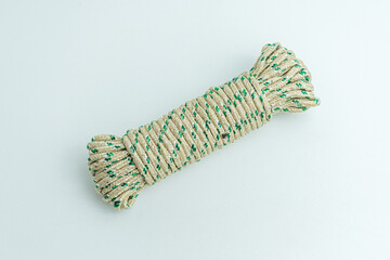 Rolled bundle of green and white twisted string rope isolated on white background © arbi wiratama