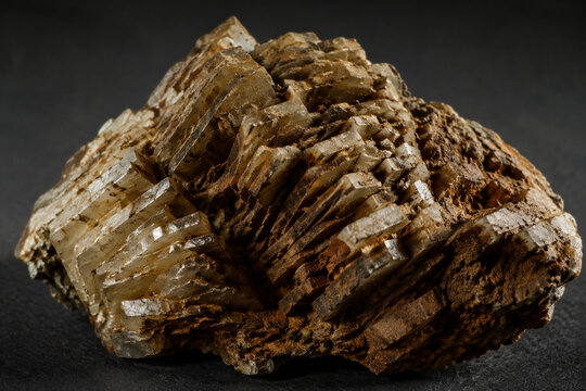 Macro view of broken barite ore showing its tabular crystal structure and earthy texture.