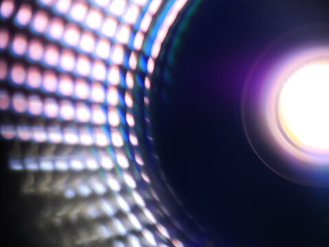 LED lamp. Defocused close-up of a bright LED lamp creating a colorful abstract grid pattern. Can be used as elements for design projects.