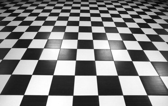Chess perspective floor background. Black and white chessboard perspective floor texture. Checker board pattern surface. Fading away vanishing checkerboard background. Abstract vector illustration.