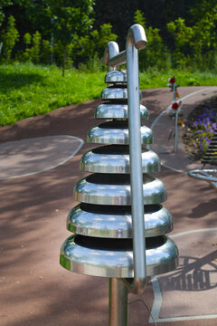 Outdoor metal musical instrument xylophone on a clear sunny day. Playgrounds, sports, health, entertainment.