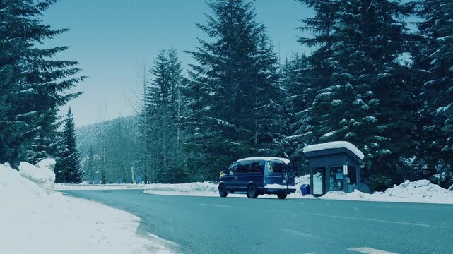 Mountain Road With Bus Shelter In Snowfall
